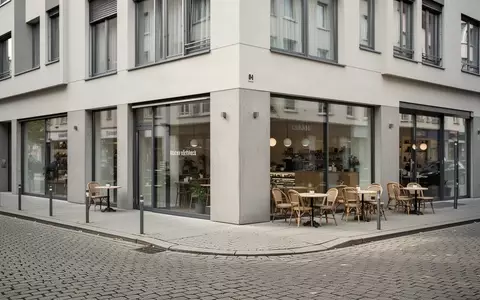 Ein ruhiges, modernes Straßenbild mit einem Café in einer deutschen Stadt bei Tageslicht, ohne Menschen oder Schilder. - Foto: über boerse-global.de