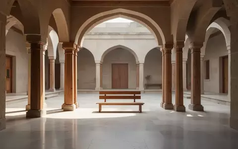 Ein sonnendurchfluteter, minimalistischer Innenhof in einem Ashram mit Steinboden und Holzsäulen. - Foto: über boerse-global.de
