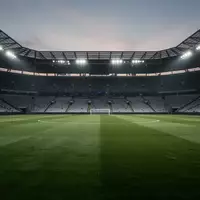 Ein leeres, gepflegtes Fußballfeld in einem Stadion bei Dämmerung. - Foto: über boerse-global.de