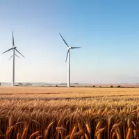 Eine Windkraftanlage in einem weiten Getreidefeld unter blauem Himmel. - Foto: über boerse-global.de