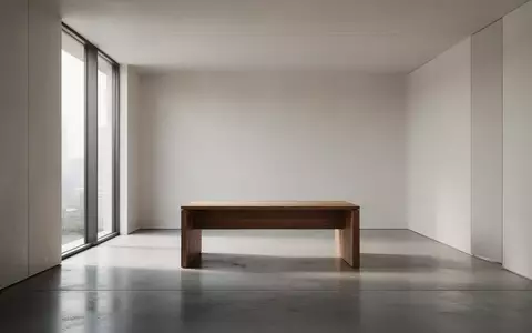 Ein minimalistischer, moderner Innenraum mit hellem Lichteinfall und einem leeren Schreibtisch. - Foto: über boerse-global.de