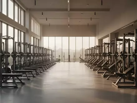 Ein minimalistisch gestalteter Fitnessraum mit hochwertigen Trainingsgeräten und hellem Tageslicht, ohne Personen. - Foto: über boerse-global.de