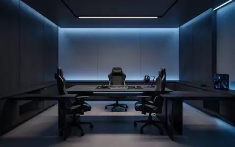 Ein modern eingerichtetes Gaming-Zimmer mit minimalistischem Schreibtisch und stimmungsvoller blauer Beleuchtung. - Foto: über boerse-global.de