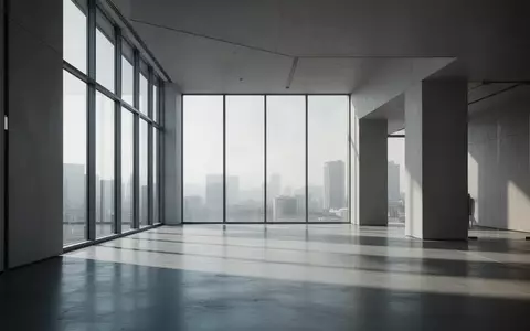 Minimalistischer, moderner Innenraum mit klaren architektonischen Linien und natürlichem Lichteinfall durch große Fenster. - Foto: über boerse-global.de