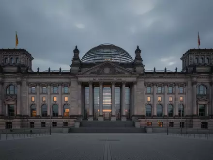 Das Reichstagsgebäude in Berlin in der Abenddämmerung mit Fokus auf die Architektur und die Glaskuppel. - Foto: über boerse-global.de