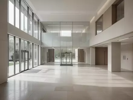 Ein minimalistisches, helles Interieur eines modernen Verwaltungsgebäudes mit klaren architektonischen Linien und Tageslicht. - Foto: über boerse-global.de