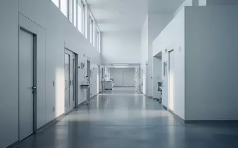 Ein minimalistischer, leerer Flur in einem modernen Forschungslabor mit kühlem Tageslicht und reflektierenden Bodenflächen. - Foto: über boerse-global.de
