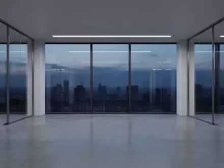 Ein minimalistisch gestalteter, leerer Büroflur in einem modernen Gebäude bei Dämmerung, der Stabilität und Ordnung ausstrahlt. - Foto: über boerse-global.de