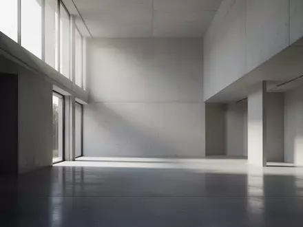 Ein minimalistischer, leerer Architekturraum mit klaren Linien und hellem, natürlichem Tageslicht. - Foto: über boerse-global.de