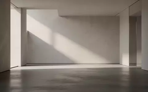 Ein minimalistischer, moderner Innenraum mit klaren geometrischen Flächen und weichem, diffusem Tageslicht. - Foto: über boerse-global.de