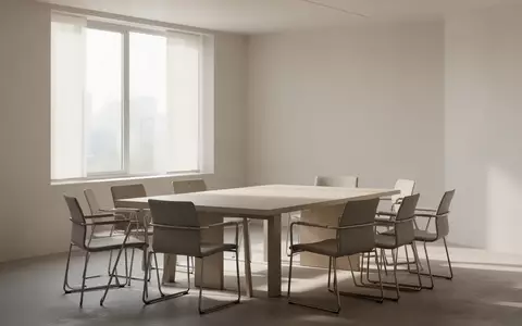 Ein heller, leerer Beratungsraum mit einem Holztisch und Stühlen in einer ruhigen, professionellen Umgebung. - Foto: über boerse-global.de