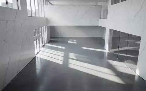 Minimalistische, moderne Architektur mit klaren Linien und hellem Lichteinfall in einem leeren, weitläufigen Gebäudeinnenraum. - Foto: über boerse-global.de
