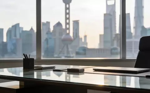 Ein minimalistischer Schreibtisch in einem modernen Büro vor der Kulisse einer Finanzmetropole bei Tageslicht. - Foto: über boerse-global.de