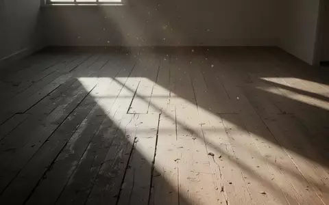 Ein leerer, sonnendurchfluteter Raum mit langen Schatten auf einem hölzernen Boden, der eine Atmosphäre der Stille vermittelt. - Foto: über boerse-global.de