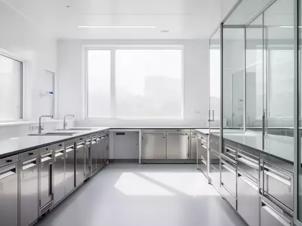 Ein minimalistisches, modernes Labor mit sauberen weißen Oberflächen und natürlichem Licht, das auf leere Medizinschränke fällt. - Foto: über boerse-global.de