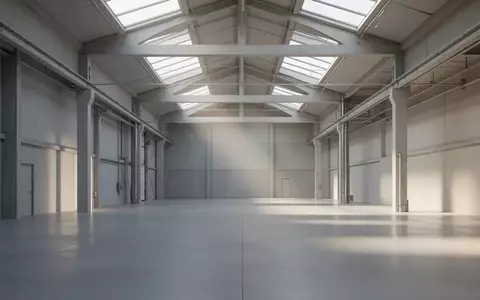 Ein minimalistisches, lichtdurchflutetes Industriegebäude mit hohen Decken und Betonboden ohne Personen. - Foto: über boerse-global.de
