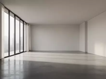 Ein minimalistischer, moderner Innenraum mit poliertem Betonboden und natürlichem Licht, das durch große Fenster fällt. - Foto: über boerse-global.de