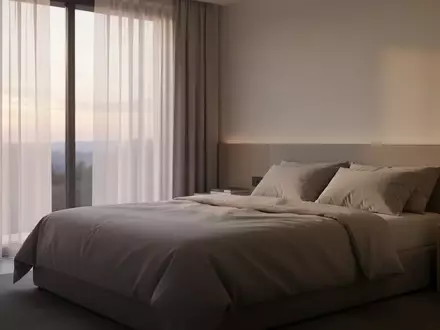 Ein minimalistisch eingerichtetes, helles Schlafzimmer bei Tagesanbruch, das eine ruhige und private Atmosphäre vermittelt. - Foto: über boerse-global.de
