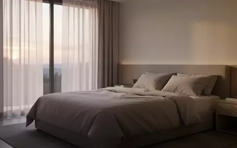 Ein minimalistisch eingerichtetes, helles Schlafzimmer bei Tagesanbruch, das eine ruhige und private Atmosphäre vermittelt. - Foto: über boerse-global.de