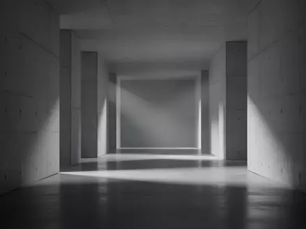 Ein minimalistischer, modern gestalteter Flur mit schlichten Betonwänden und diffusem Licht, der eine Atmosphäre technischer Komplexität erzeugt. - Foto: über boerse-global.de