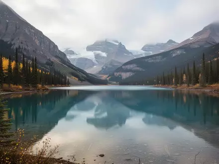 Eine weitläufige Berglandschaft mit einem klaren Gebirgssee und Nadelwäldern unter einem bewölkten Himmel in Kanada. - Foto: über boerse-global.de