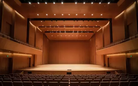Innenansicht einer modernen Konzerthalle in Shenzhen mit minimalistischer Architektur und warmer Beleuchtung. - Foto: über boerse-global.de