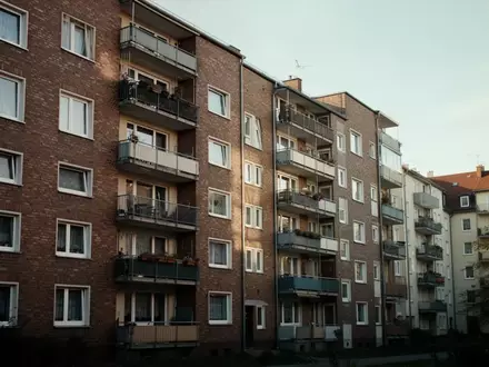 Fassade eines Wohngebäudes einer Baugenossenschaft in einem deutschen Stadtviertel bei Tageslicht. - Foto: über boerse-global.de