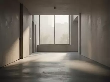 Ein leerer, minimalistischer Flur in einem modernen Gebäude mit natürlichem Lichteinfall und sanften Schatten. - Foto: über boerse-global.de