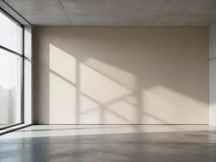 Ein minimalistischer Innenraum mit klaren architektonischen Linien und weichem, natürlichem Licht, das geometrische Schatten wirft. - Foto: über boerse-global.de