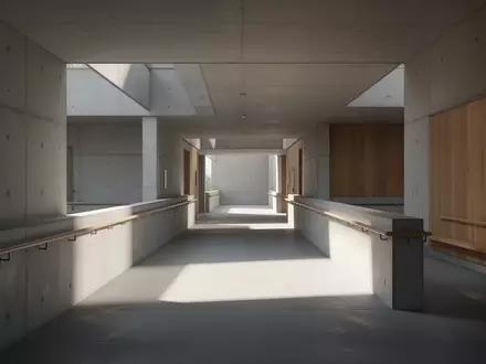 Ein barrierefreies, modern gestaltetes Gebäudeinnere mit einer Rampe und klaren architektonischen Linien bei natürlichem Licht. - Foto: über boerse-global.de