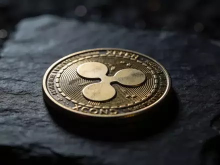 Ein einzelnes digitales XRP-Symbol auf einer dunklen Schieferplatte in stimmungsvollem, schattigem Licht. - Foto: über boerse-global.de