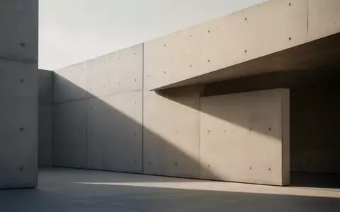 Minimalistische moderne Architektur mit klaren Linien und geometrischen Schattenwürfen auf einer Betonfassade - Foto: über boerse-global.de
