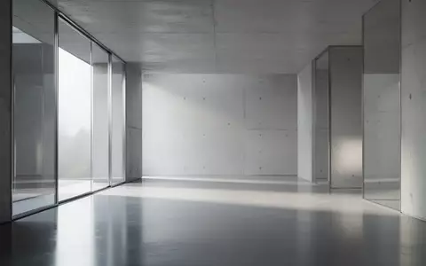 Ein minimalistischer, moderner Innenraum mit klaren Linien, poliertem Beton und einfallendem Tageslicht. - Foto: über boerse-global.de