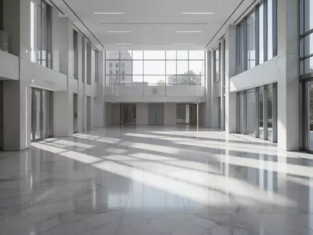 Ein minimalistisches, helles Innenraumfoto eines öffentlichen Gebäudes mit poliertem Boden und geometrischen Schatten. - Foto: über boerse-global.de