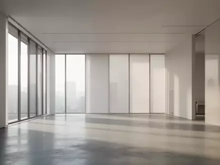 Ein minimalistischer, moderner Innenraum mit hellem Tageslicht, das auf einen polierten Betonboden fällt. - Foto: über boerse-global.de