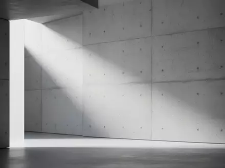 Minimalistisches, modernes Architekturdesign mit klaren Linien und weichem Licht auf einer strukturierten Betonwand. - Foto: über boerse-global.de