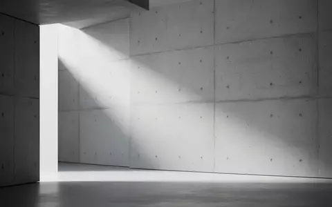 Minimalistisches, modernes Architekturdesign mit klaren Linien und weichem Licht auf einer strukturierten Betonwand. - Foto: über boerse-global.de