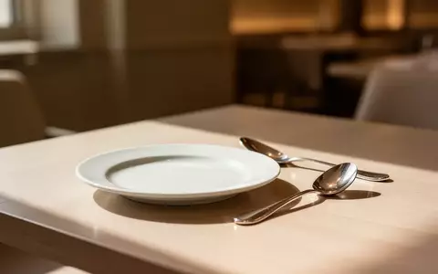 Ein minimalistisch gedeckter Tisch in einem eleganten Restaurant mit einem leeren Dessertteller und einem Kaffeelöffel. - Foto: über boerse-global.de