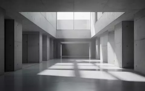 Ein minimalistischer, leerer Flur in einem modernen Gebäude mit klaren architektonischen Linien und einfallendem Tageslicht. - Foto: über boerse-global.de
