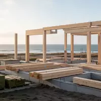 Baustelle für ein nachhaltiges Wohn- und Gewerbeprojekt auf Sylt mit Holzbau-Elementen in einer flachen Küstenlandschaft. - Foto: über boerse-global.de