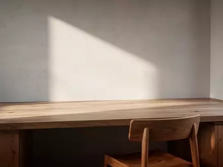 Ein minimalistischer Arbeitsplatz mit hellem Holztisch und natürlichem Lichteinfall in einem modern eingerichteten Raum. - Foto: über boerse-global.de