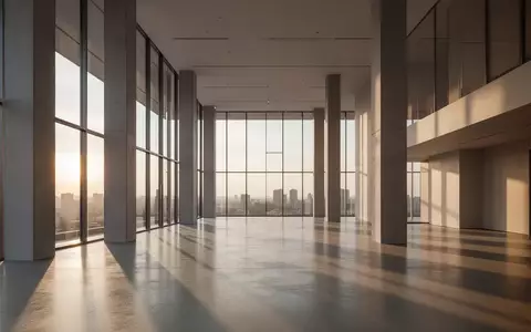 Ein minimalistisches, modernes Bürogebäude mit hohen Decken und einfallendem Sonnenlicht, das lange Schatten auf den Boden wirft. - Foto: über boerse-global.de