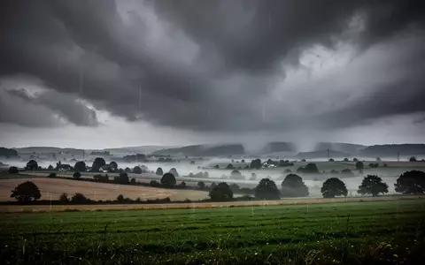 Dramatische Regenwolken über einer ländlichen Landschaft in Rheinland-Pfalz während eines Unwetters. - Foto: über boerse-global.de