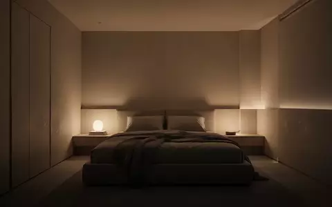 Ein minimalistisches, modern eingerichtetes Schlafzimmer mit stimmungsvoller, warmer Beleuchtung in einer ruhigen Atmosphäre. - Foto: über boerse-global.de