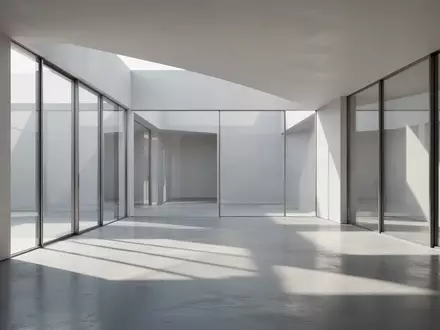 Ein minimalistischer, moderner Innenraum mit klaren architektonischen Linien und natürlichem Lichteinfall auf einem polierten Betonboden. - Foto: über boerse-global.de