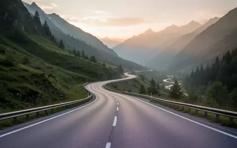 Eine leere, geschwungene Asphaltstraße in einem grünen Tal bei Sonnenaufgang, die den Fokus auf Ausdauersport und Bewegung legt. - Foto: über boerse-global.de