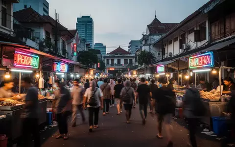 Eine belebte städtische Marktstraße in Jakarta bei Dämmerung mit atmosphärischer Beleuchtung und geschäftigem Treiben. - Foto: über boerse-global.de