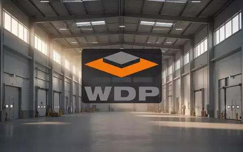 Moderne, weitläufige Lagerhalle in einer professionellen Industrieumgebung bei Sonnenaufgang. - Foto: über boerse-global.de