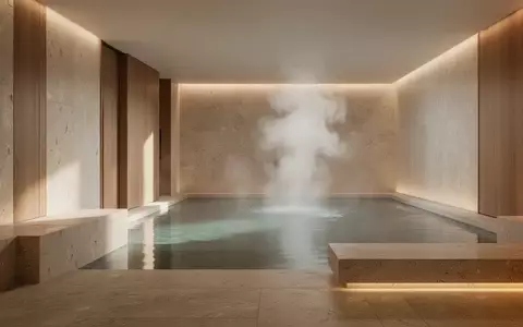 Ein minimalistischer Wellnessbereich mit Naturstein und warmem Licht, der eine Atmosphäre der Ruhe und Regeneration ausstrahlt. - Foto: über boerse-global.de