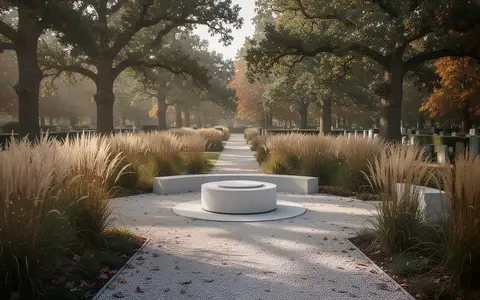 Ein naturnaher Friedhof mit einem schlichten Urnenrondell, umgeben von Gräsern und Bäumen bei sanftem Tageslicht. - Foto: über boerse-global.de